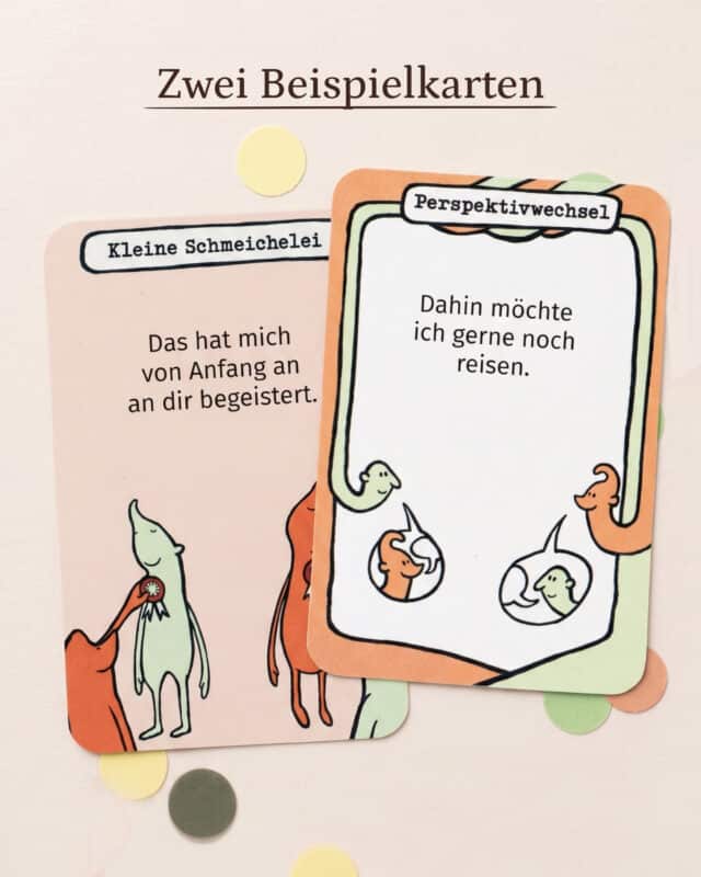 Zwei Fragekarten aus PaarMinuten Gute Laune auf hellrosa Untergrund mit Konfetti: „Kleine Schmeichelei – Das hat mich von Anfang an an dir begeistert.“ und „Perspektivwechsel – Dahin möchte ich gerne noch reisen.“