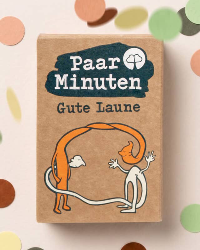 Schachtel PaarMinuten Gute Laune aus Kraftpapier mit zwei ausgelassen tanzenden Figuren, ringsum buntes Konfetti